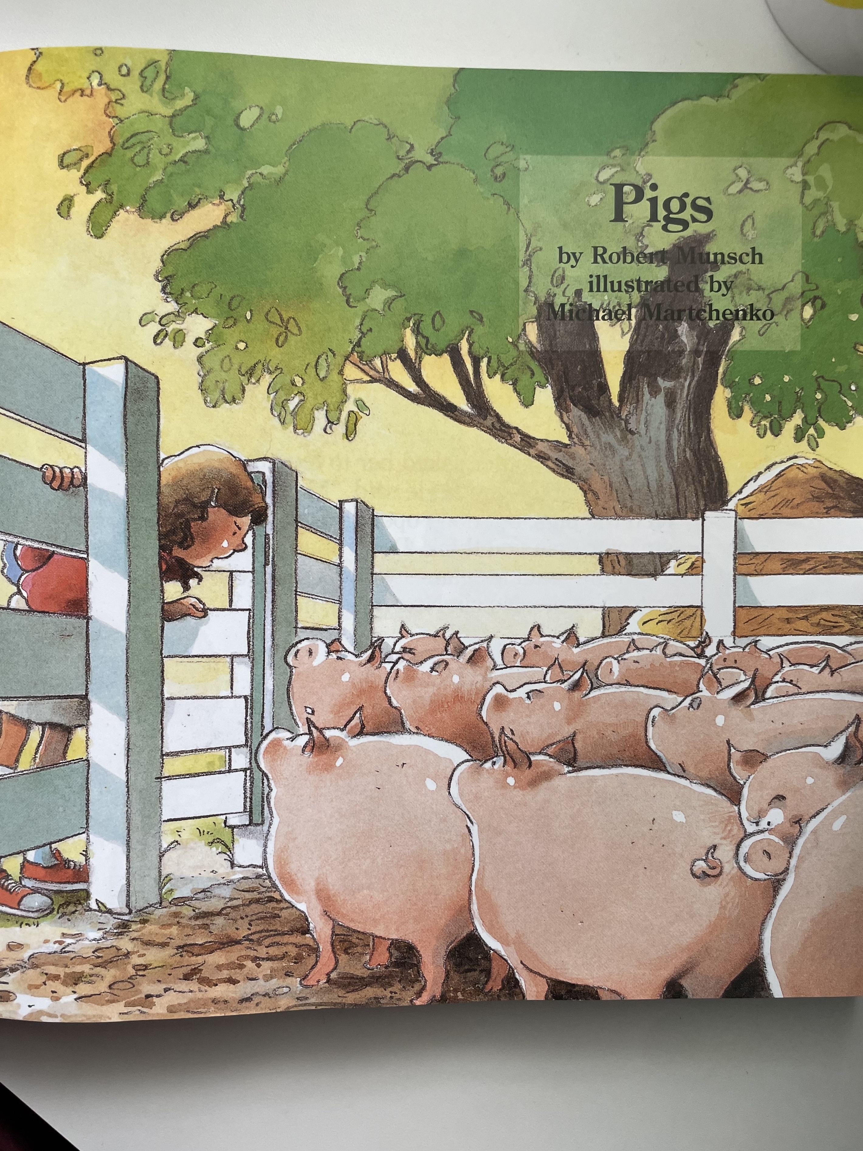 Illustration from a children&#x27;s book showing a child looking over a fence at a group of pigs