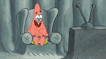 Patrick Star from SpongeBob SquarePants is sitting, looking happy with crossed legs