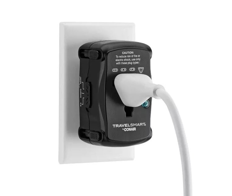 An adapter plugged into a wall outlet with a cord connected to it