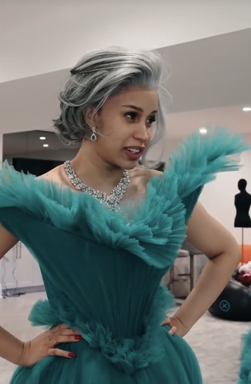 Cardi B in a voluminous turquoise gown with a ruffled skirt and a sparkling necklace