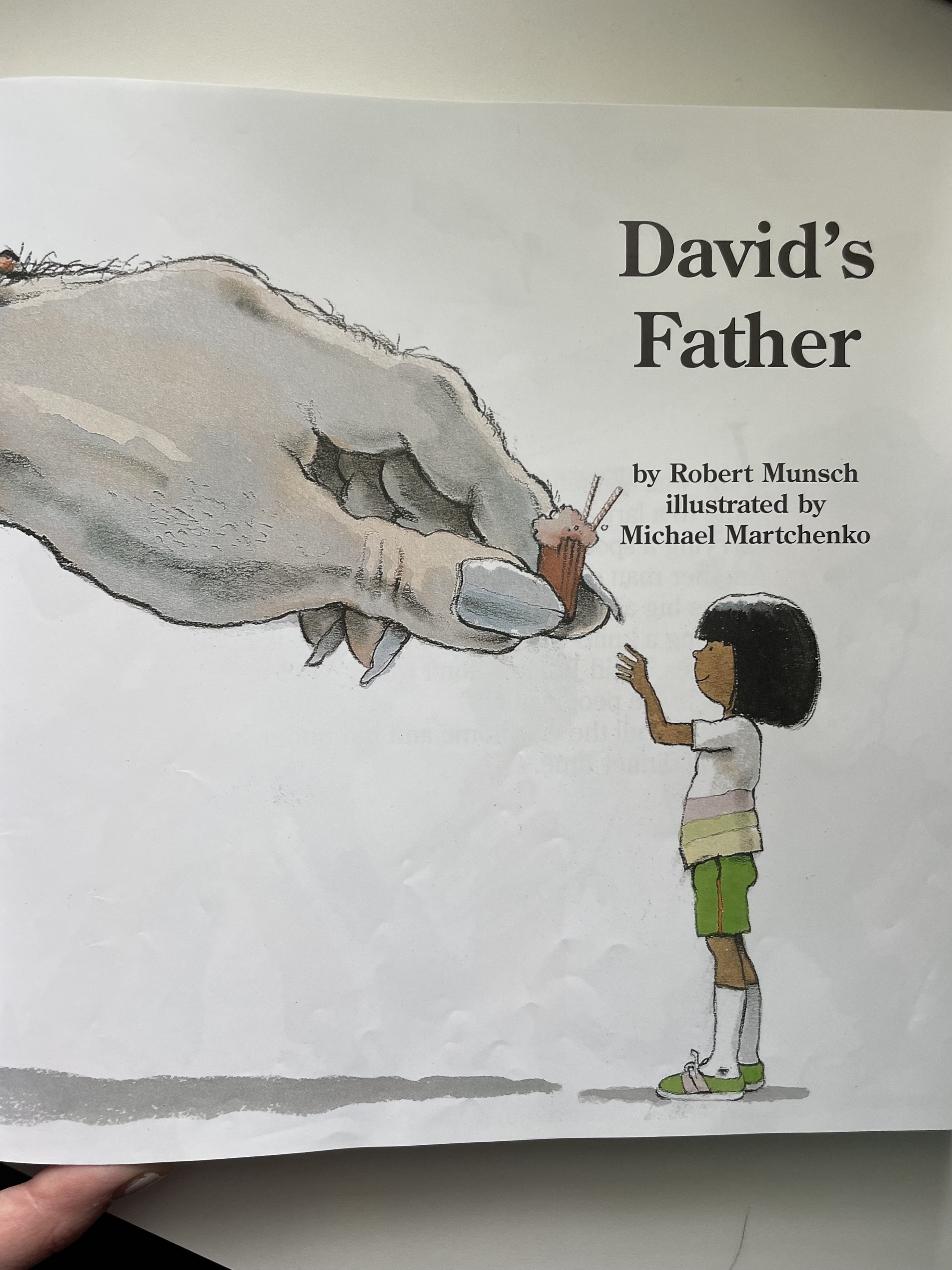 Book cover with the title &quot;David&#x27;s Father&quot; showing a child facing a giant illustrated elephant. Written by Robert Munsch and illustrated by Michael Martchenko