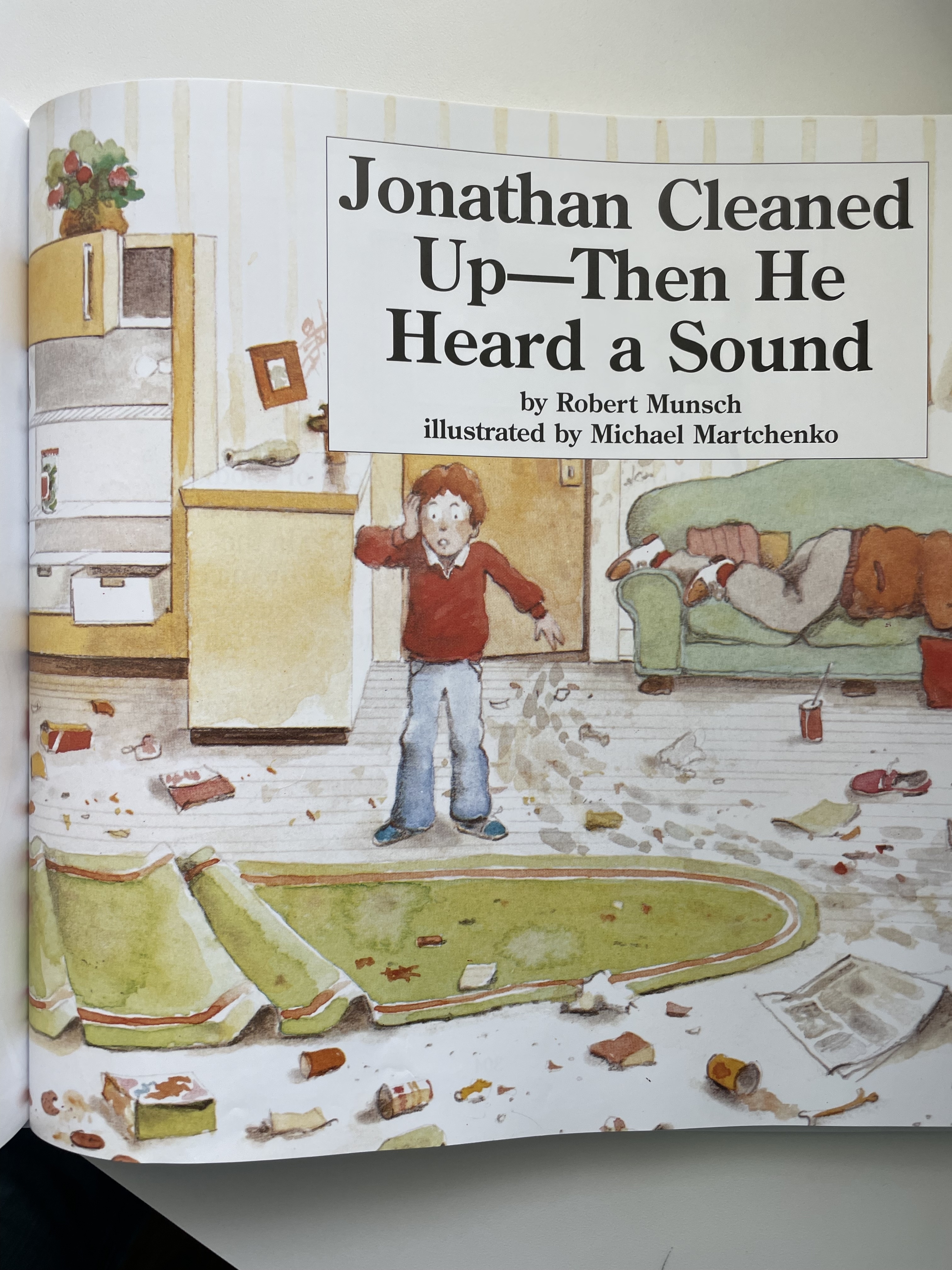 Book page from &quot;Jonathan Cleaned Up—Then He Heard a Sound&quot; showing an illustration of a startled boy in a messy room