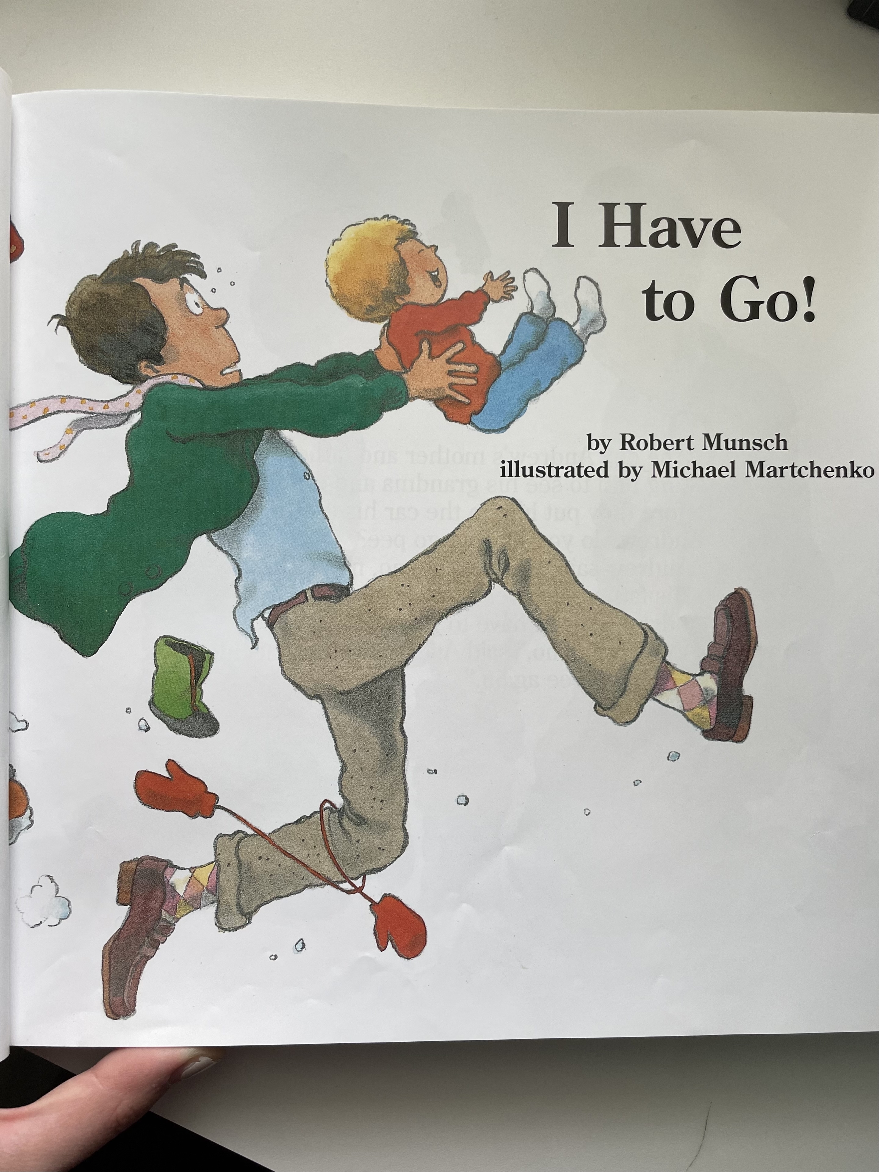 Open book showing illustrated page with title &quot;I Have to Go!&quot; and text &quot;illustrated by Michael Martchenko&quot; with two children characters