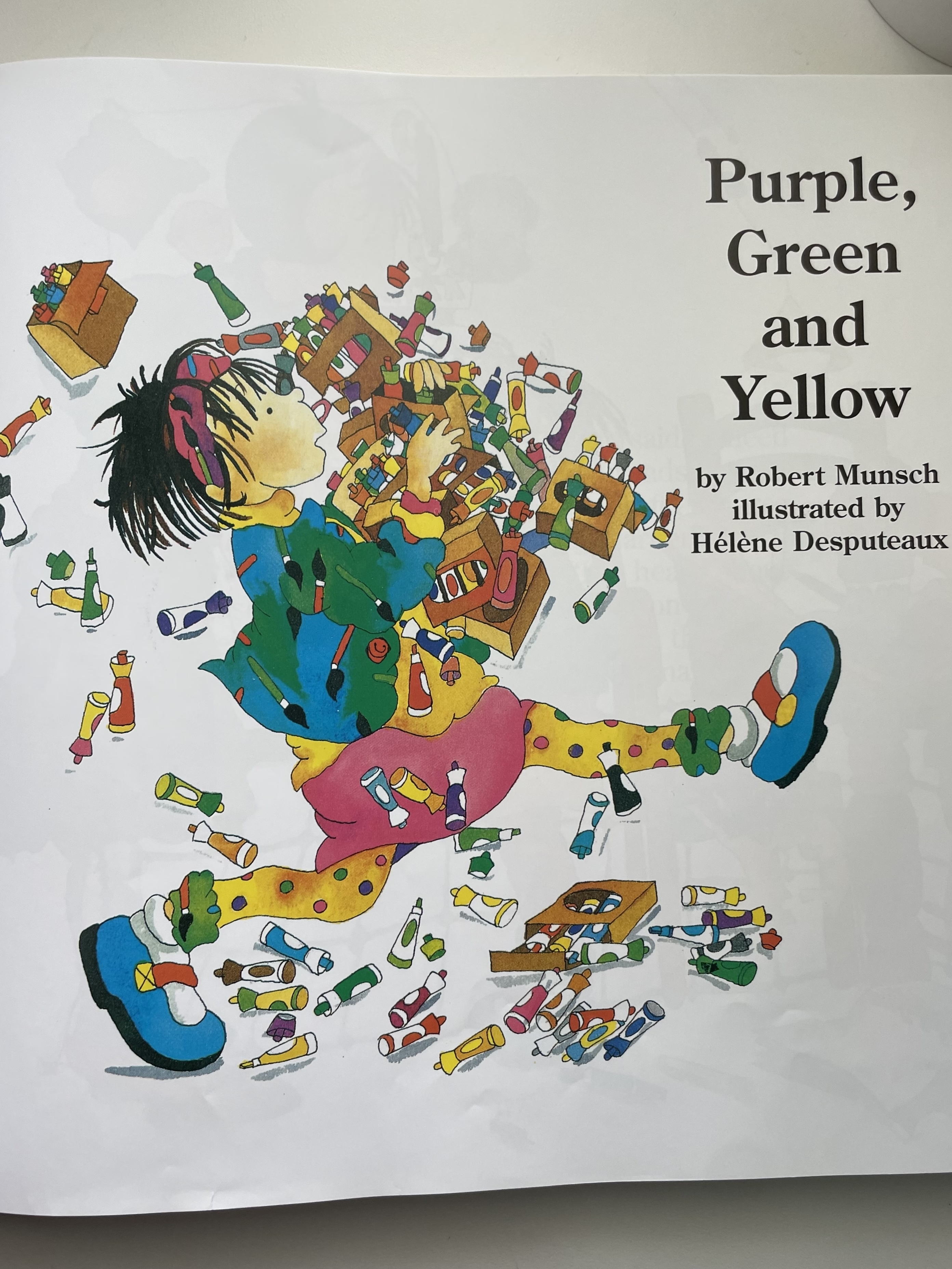 Cover of &quot;Purple, Green, and Yellow&quot; by Robert Munsch, illustrated by Hélène Desputeaux, showing a child surrounded by markers