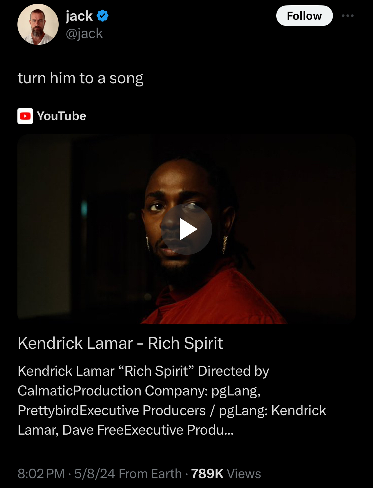 Kendrick Lamar in a music video thumbnail, looking at the camera with a serious expression