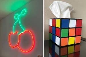 Neon cherry wall light on left; Rubik's cube tissue holder on right, unique home decor items