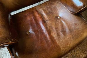 before and after of reviewer's leather chair with one half treated with conditioner and the other untreated