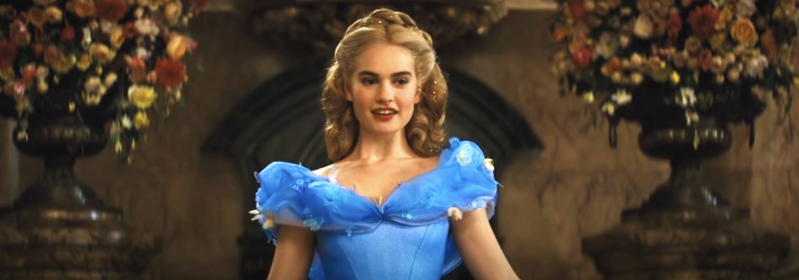 Elsa from Frozen wears a blue off-the-shoulder gown in a floral-decorated room