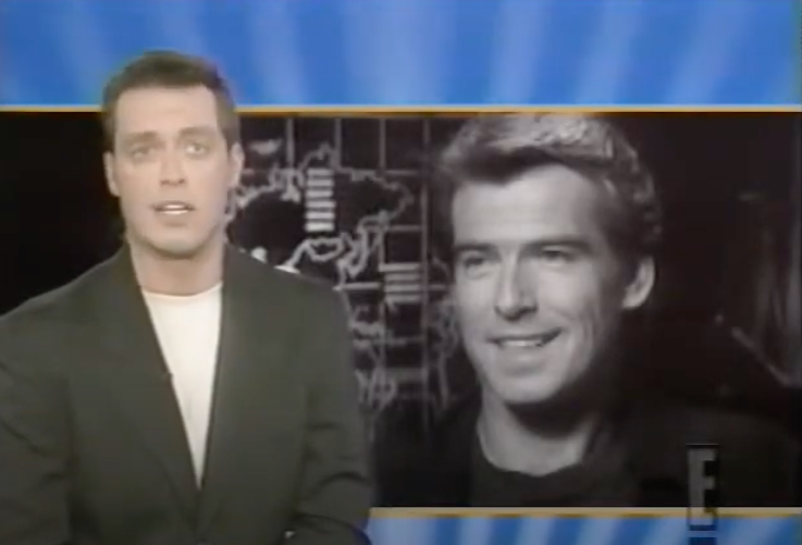 Two men on a screen; one speaking and one in a still image, both facing the camera, on a news show background