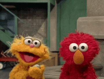 Sesame Street&#x27;s characters Elmo and Zoe smiling