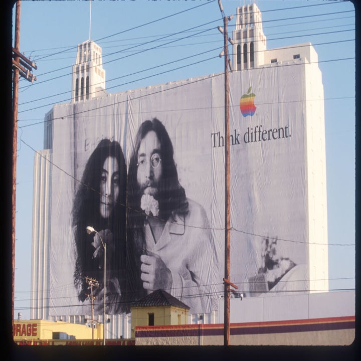 Billboard with a "Think different" slogan featuring John Lennon and Yoko Ono