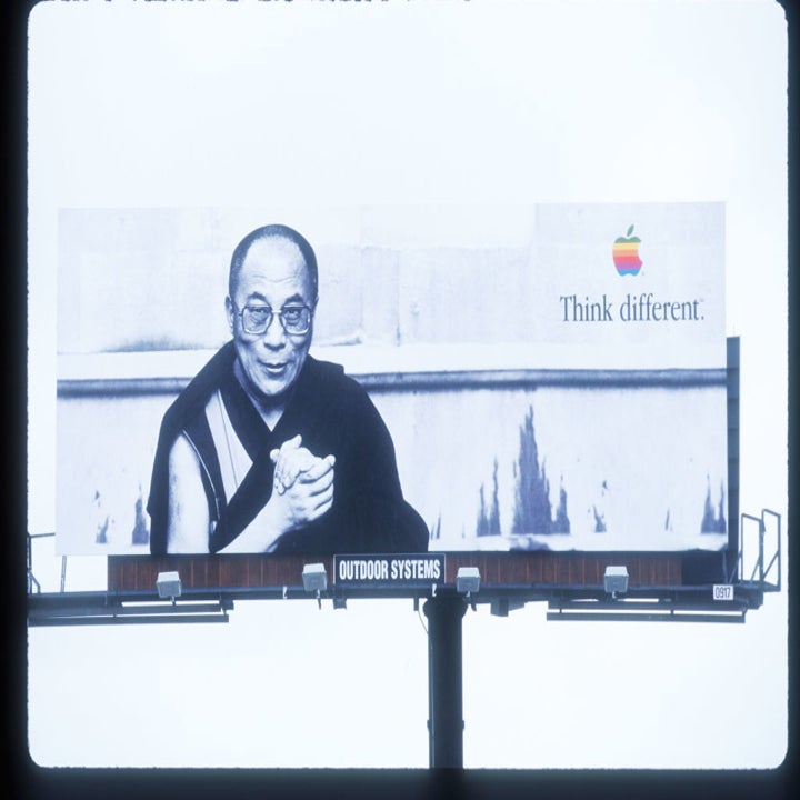 Billboard featuring the Dalai Lama with the Apple logo and slogan "Think different."
