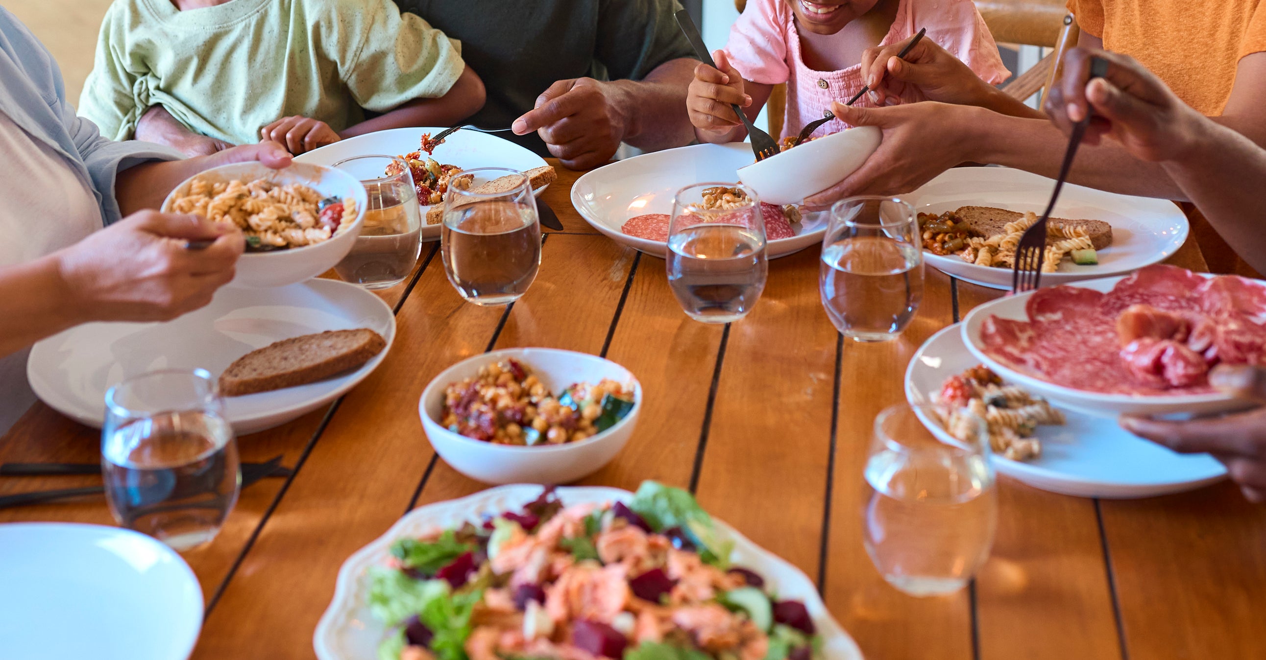 A multi-generational family enjoys a meal together around a dining table