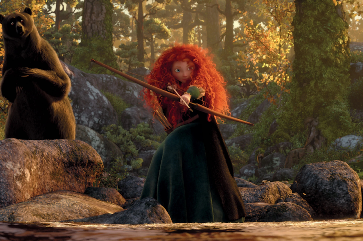 Princess Merida with bow and arrow standing on rocks beside a bear in a forest scene