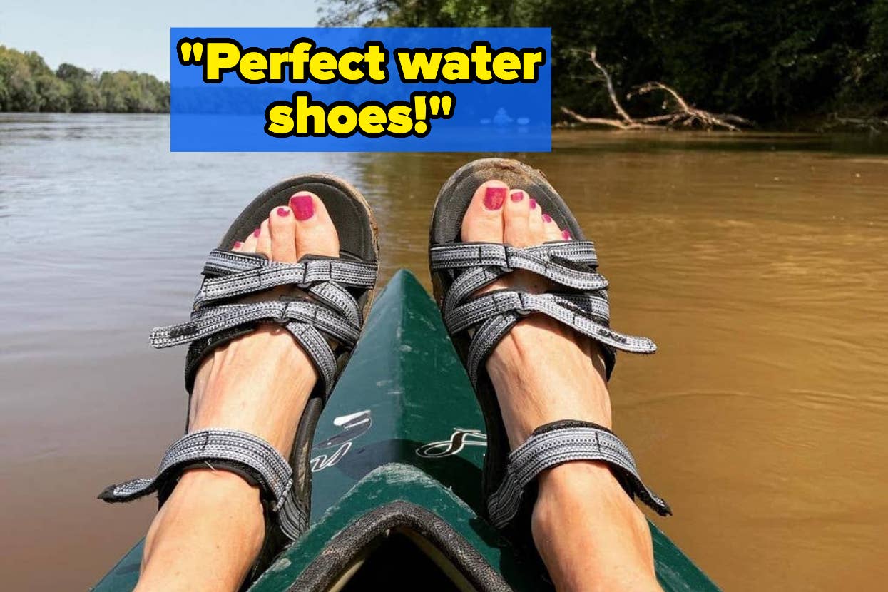 reviewer wearing teva sandals on kayak in water