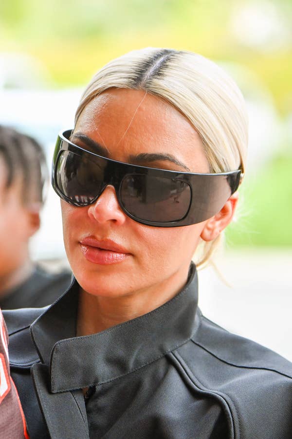 Kim Kardashian wearing oversized sunglasses and a black leather jacket