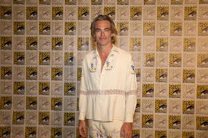 Chris Pine in patterned shirt and trousers posing at Comic-Con event