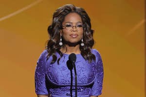 Oprah Winfrey stands at a podium on stage
