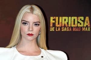 Anya Taylor Joy on red carpet in white outfit with structured shoulders, standing before a 'Furiosa' backdrop