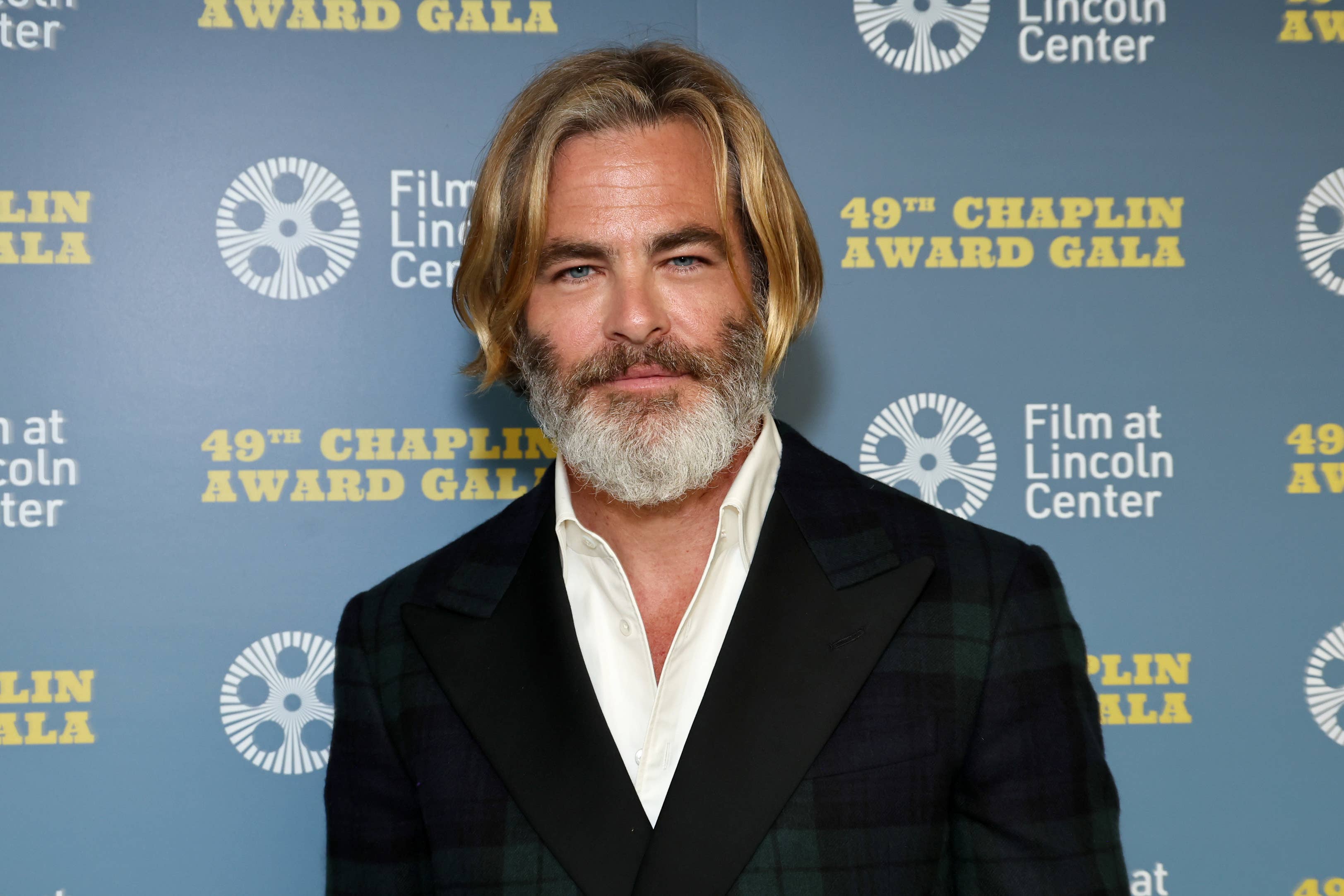 Chris Pine at an event wearing a checkered jacket and black lapel