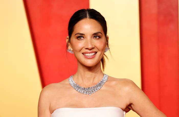 Olivia Munn on the red carpet in a strapless gown with a radiant diamond necklace and earrings