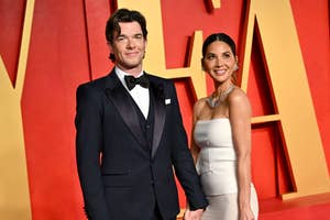 Man in a classic tuxedo and woman in an elegant strapless gown posing together
