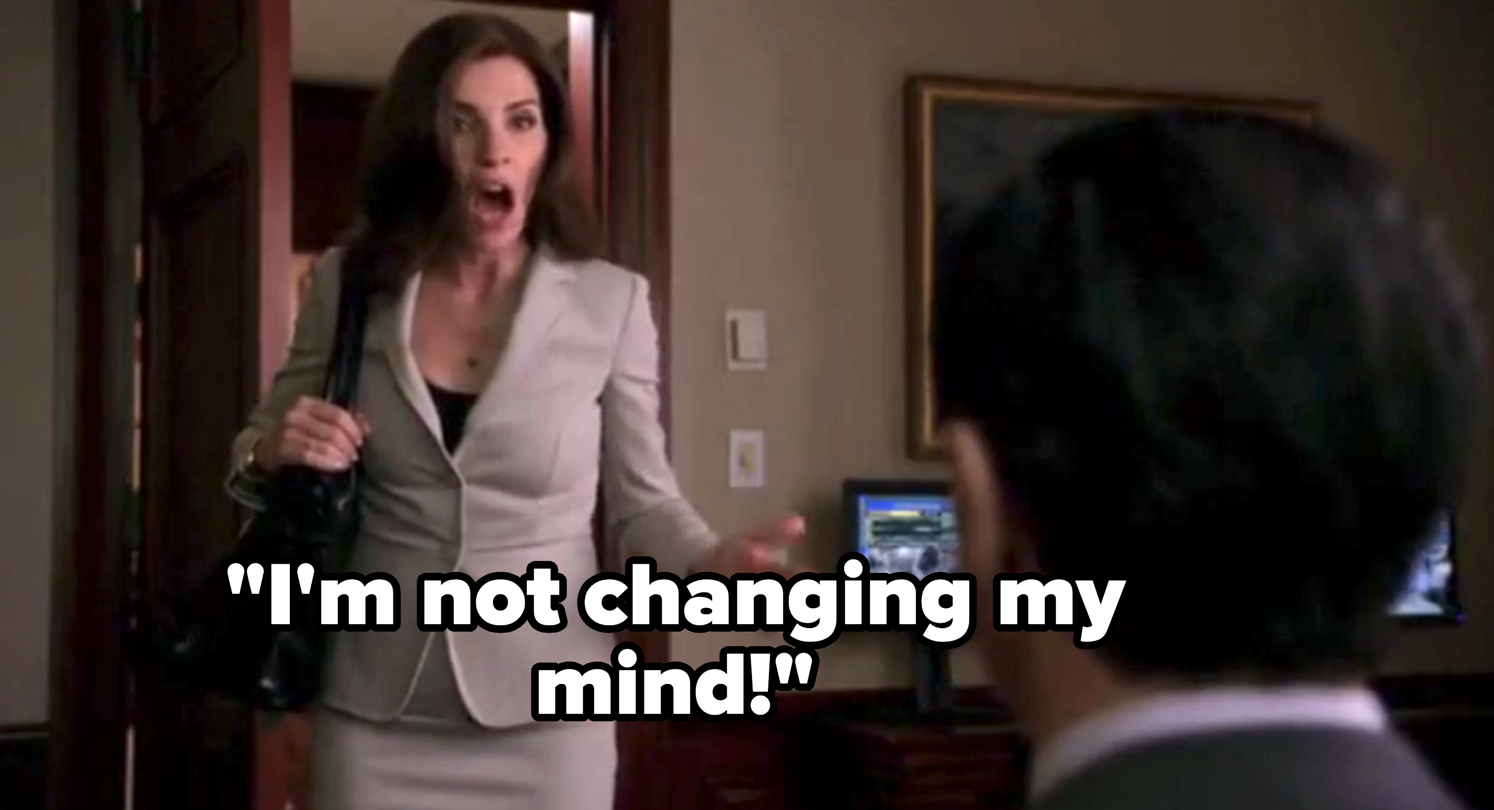 Woman in a business suit expressing surprise in an office setting