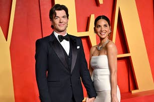Man in a classic tuxedo and woman in an elegant strapless gown posing together