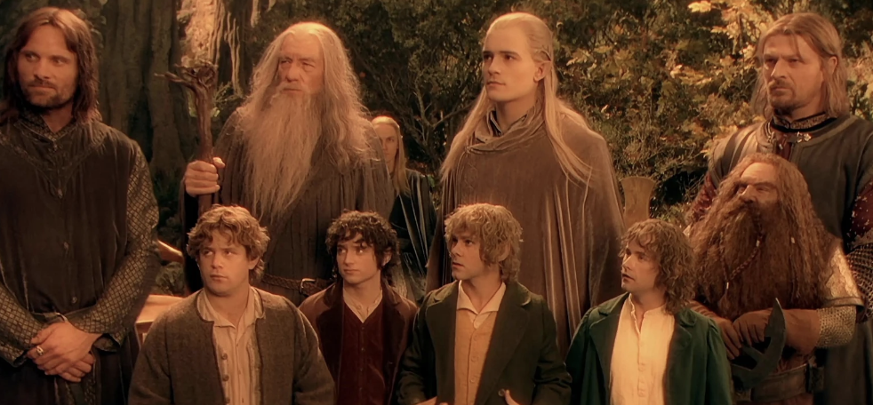 Characters from &#x27;The Lord of the Rings&#x27; including Frodo, Sam, Gandalf, Legolas, and Aragorn standing together outdoors