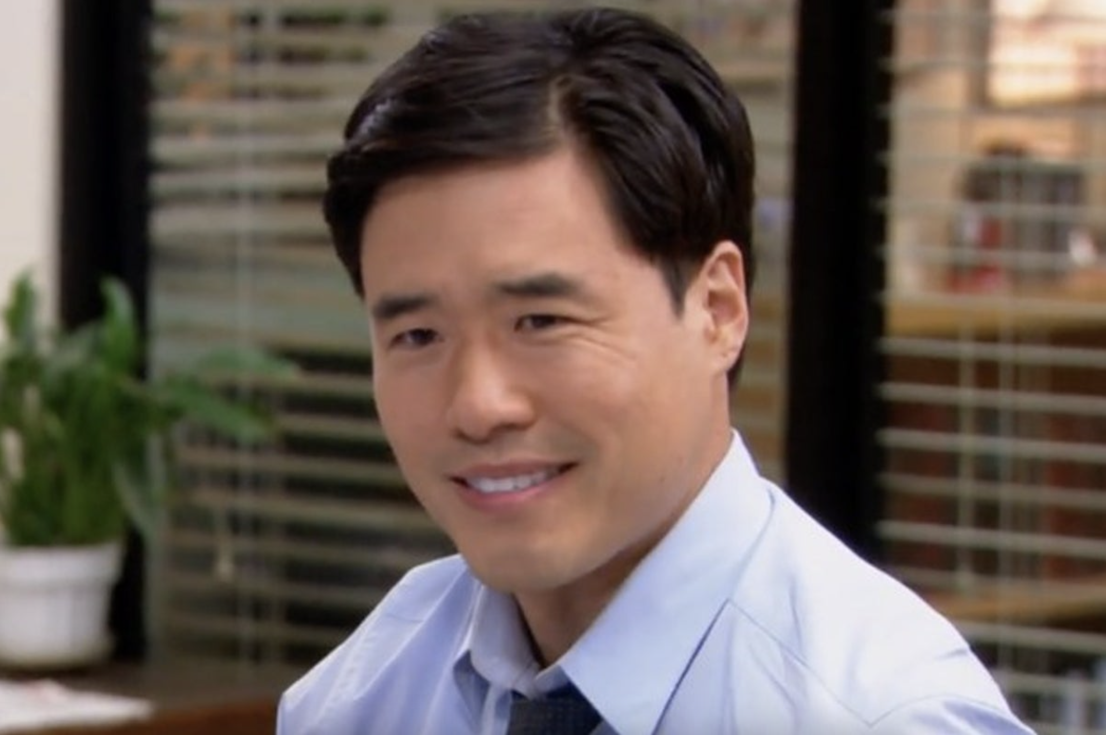 Jim Halpert from &quot;The Office&quot; smirking at the camera in an office setting