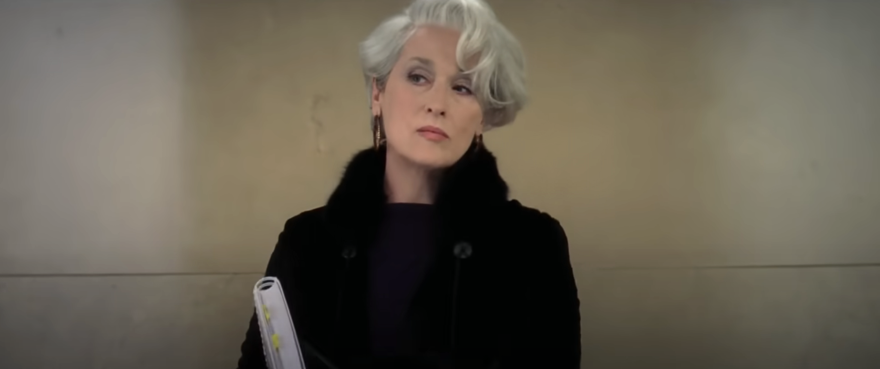 Miranda Priestly, portrayed by Meryl Streep in &#x27;The Devil Wears Prada&#x27;, is shown looking stern with a fur-trimmed coat