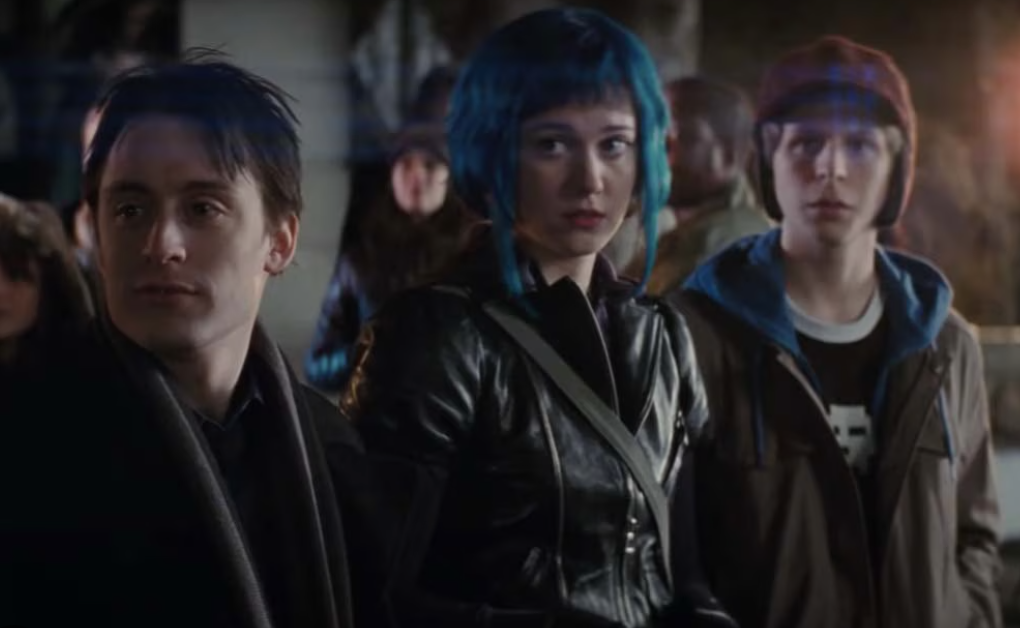 Three characters from Scott Pilgrim vs. the World, one wearing a leather jacket, another with blue hair, and the third in a beige jacket