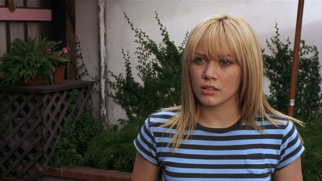 Woman in a striped top with a concerned expression