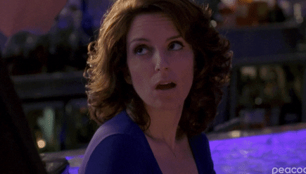 Woman in a blue dress looking surprised with an evening event in the background