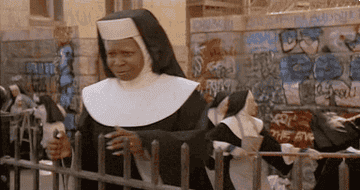 Whoopi Goldberg as a nun in &quot;Sister Act,&quot; expressing surprise with a comical facial expression