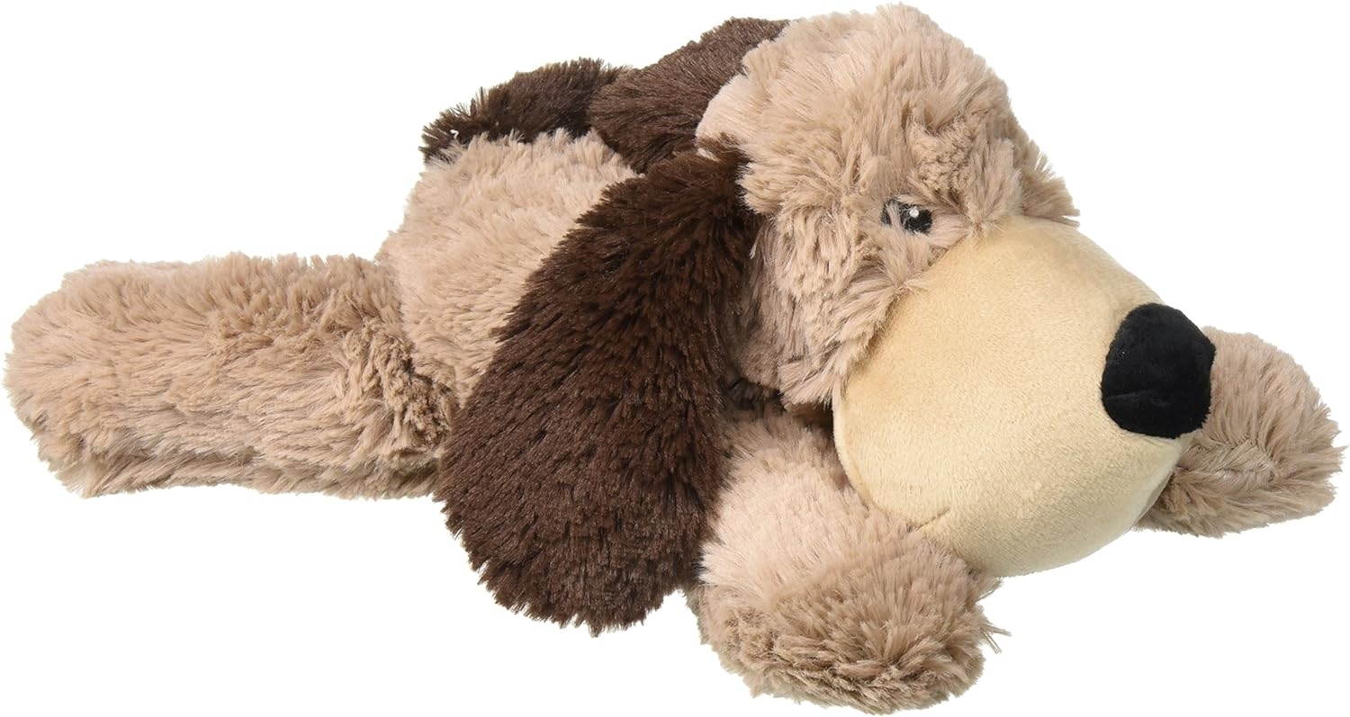 Plush toy dog lying on its side with two-toned fur and a large snout
