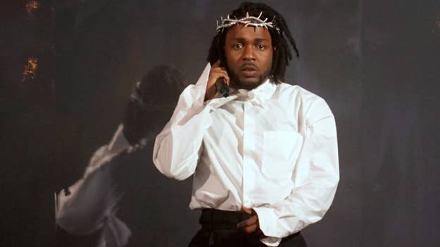 Kendrick Lamar performs on stage, wearing a thorny crown and white shirt