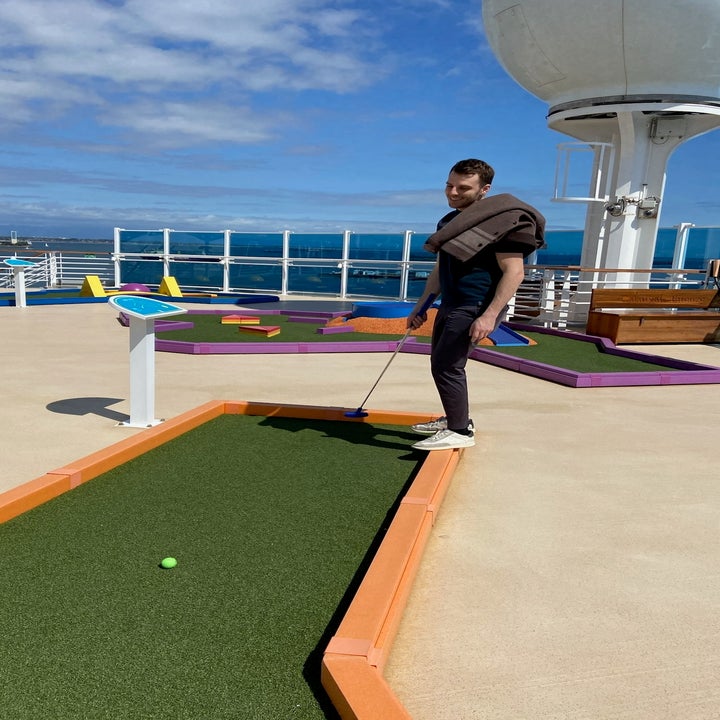 Person playing mini-golf on a cruise ship deck