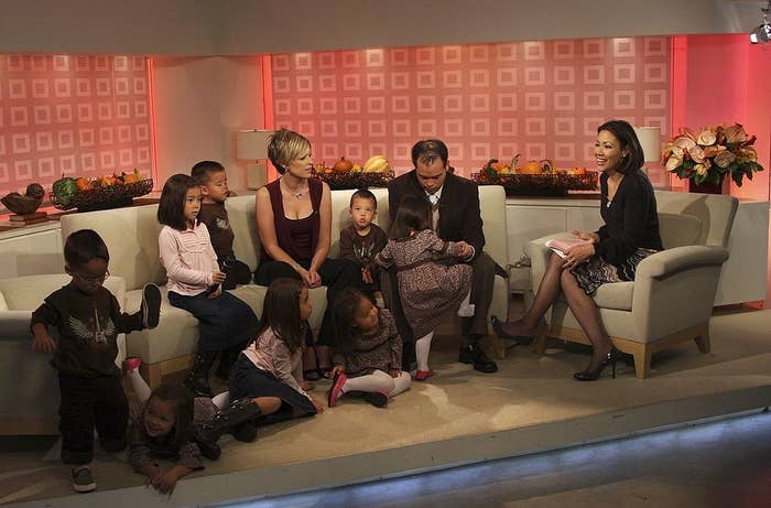 Eight individuals, including Jon &amp;amp; Kate Gosselin and their sextuplets, sit interactively during a TV interview