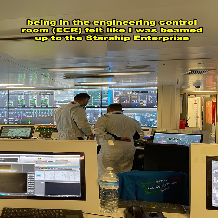 engineers working in the ship's control room while surrounded by several computer screens