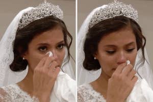 Bride in tiara and veil wiping away tears during an emotional moment
