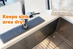 gray rectangular sink bib around the faucet