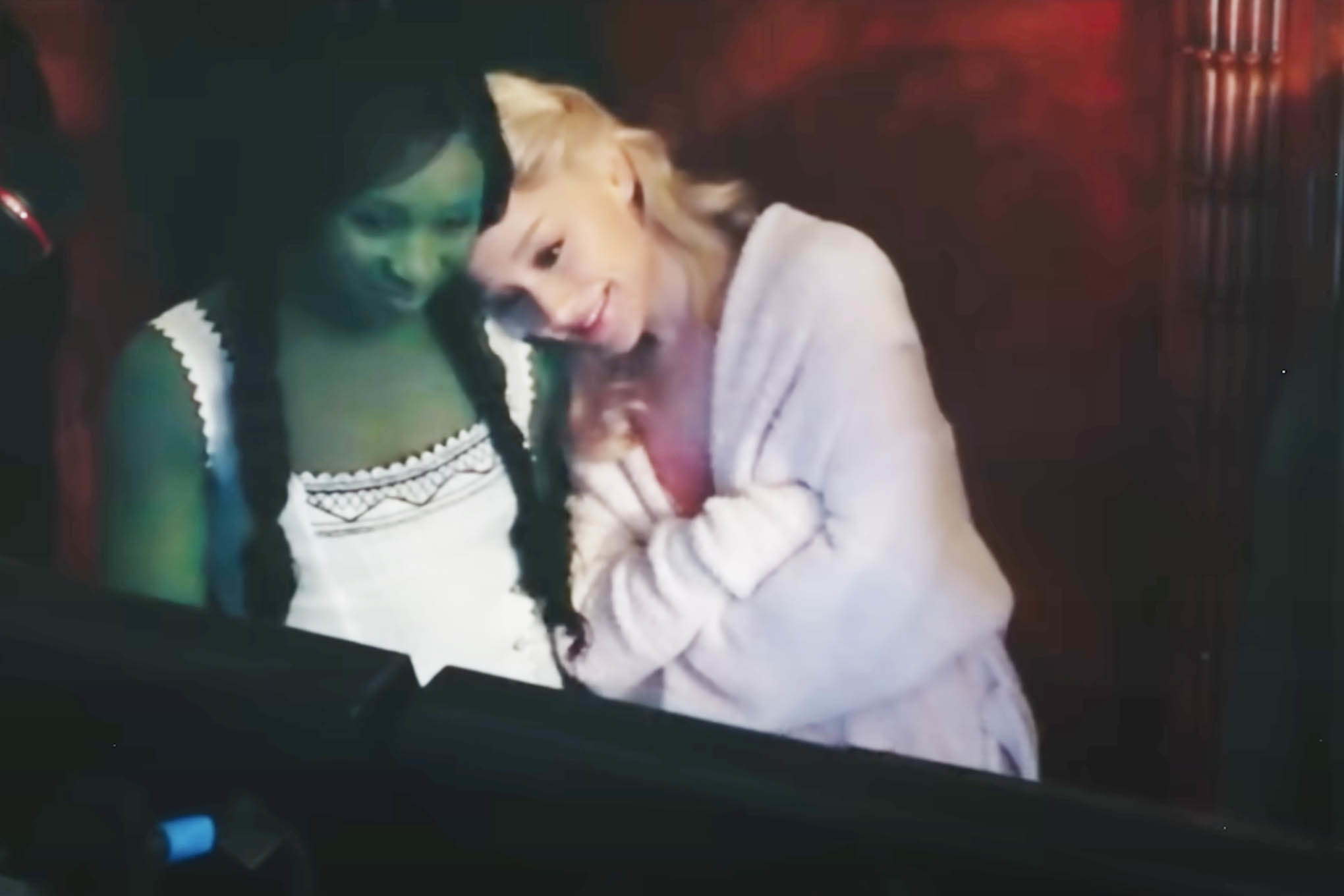 Ariana Grande resting her head on Cynthia Erivo&#x27;s shoulder behind the scenes of Wicked