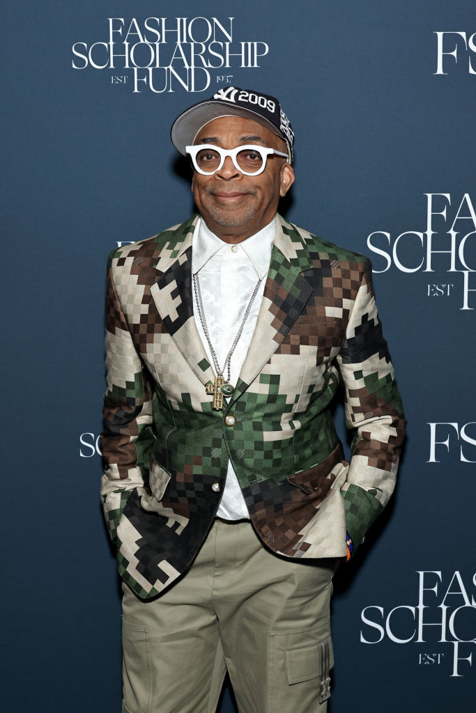 Spike Lee in a patterned blazer and cap at a fashion event
