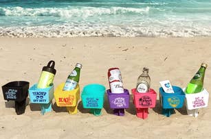 assorted colorful cupholders that stand up in the sand