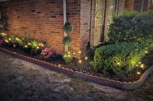 Garden bed at night with swaying garden lights