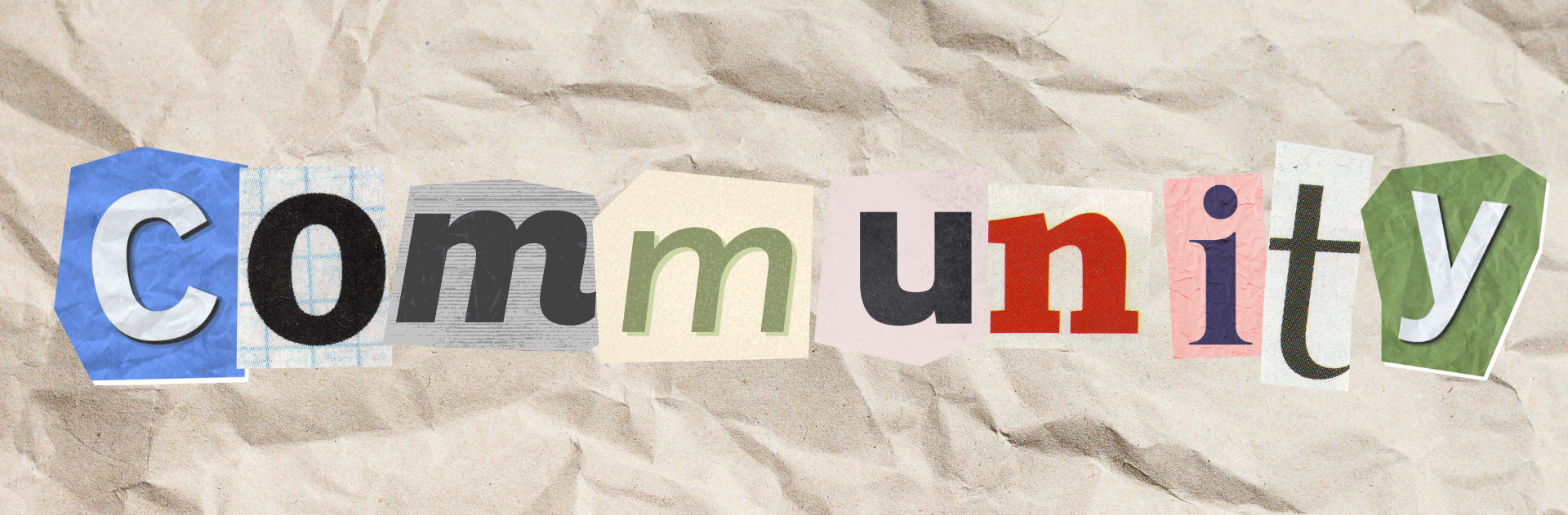 Cut-out letters spelling 'Community' on crumpled paper, concept of collaborative work atmosphere