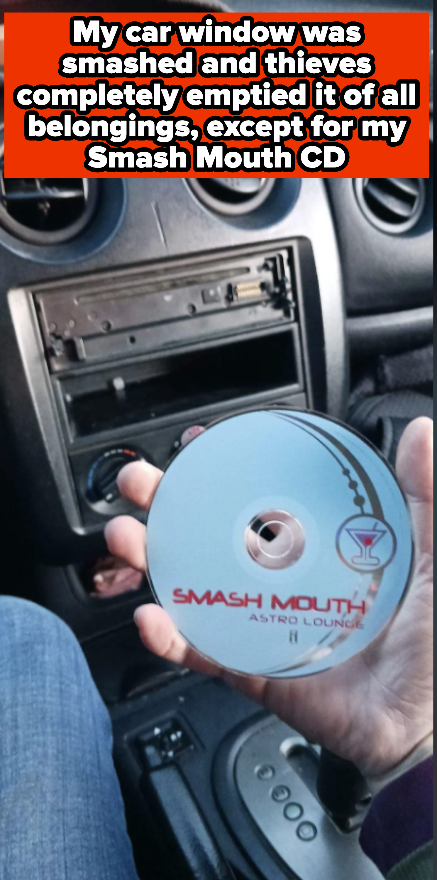 Hand holding a Smash Mouth "Astro Lounge" CD in a car's front interior with dashboard and radio visible
