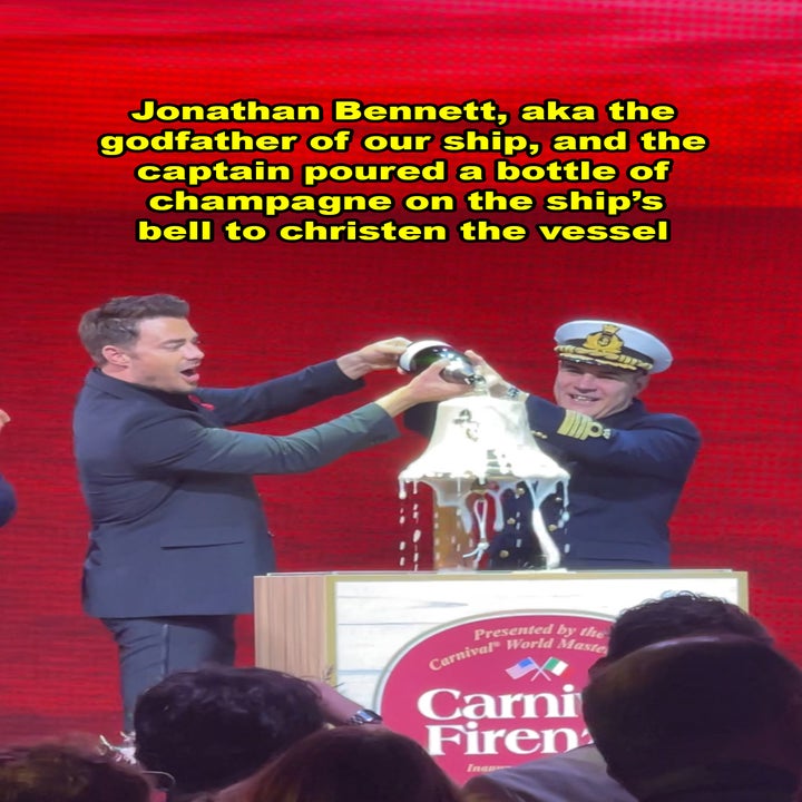 Jonathan Bennett and a captain christen a ship with champagne at a ceremony