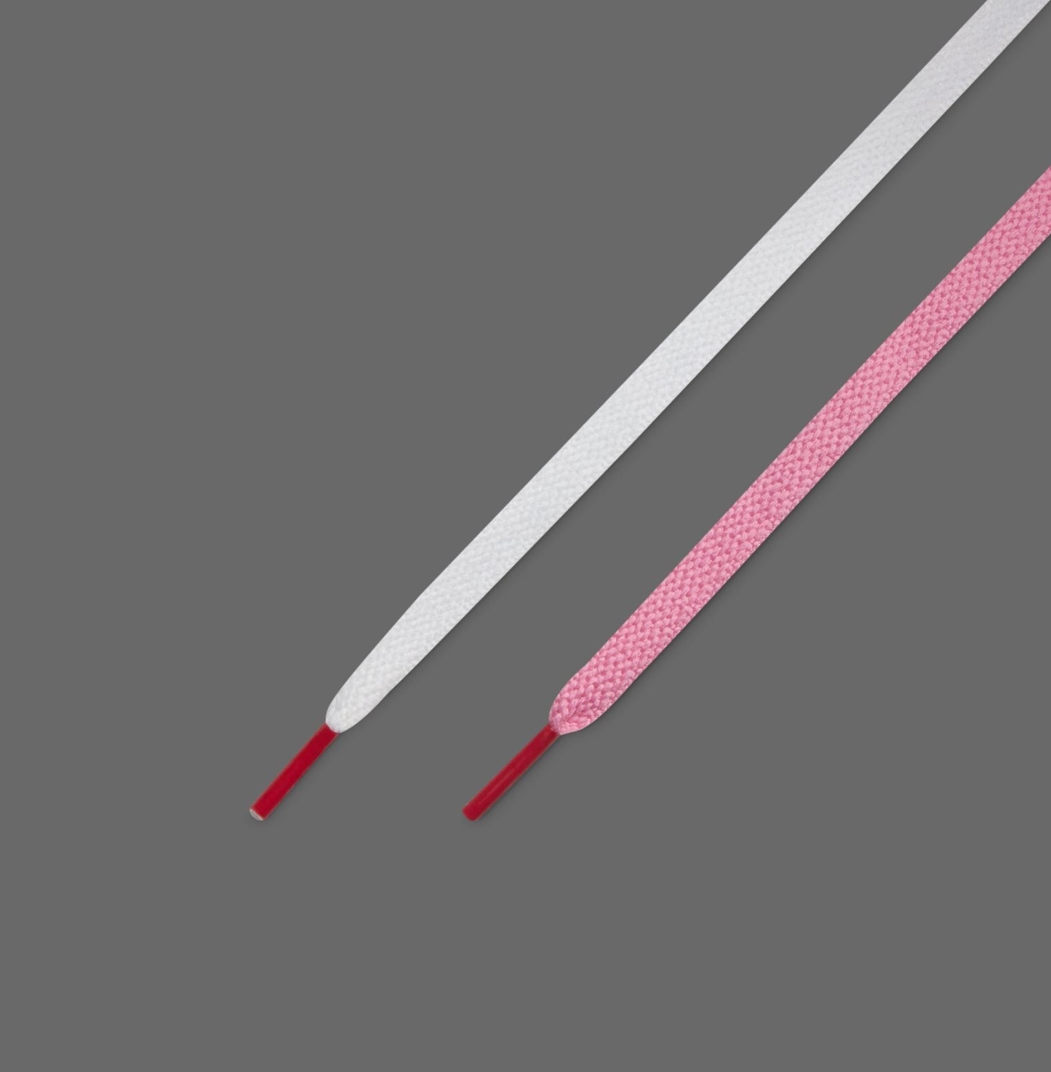 Two shoelaces, one textured, against a plain background